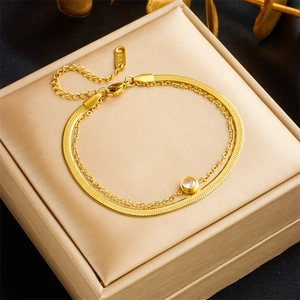 Detail view of gold titanium double-layer bracelet with zircon pendant and K18 hallmark