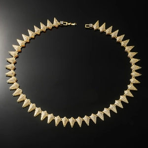 Detail of hip hop gold pyramid link necklace with iced out crystals on black background