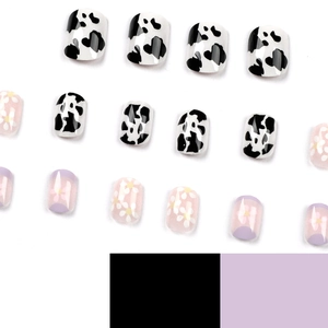 Press-on nail set featuring lavender French tips, cow prints, and daisy floral patterns