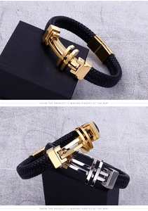 Detail of woven black leather bracelets with industrial gold and silver metal buckles