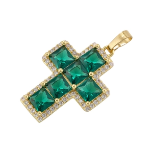 Macro detail of a gold cross pendant featuring five green square-cut cubic zirconia stones
