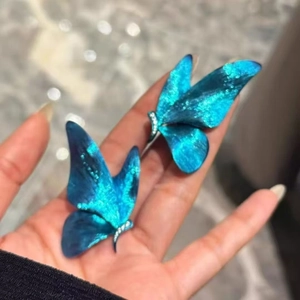 Elegant blue butterfly earrings with sparkling details and a vintage aesthetic design