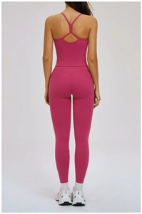 Detail of rose pink yoga set showing criss-cross back straps and butt-lifting seams