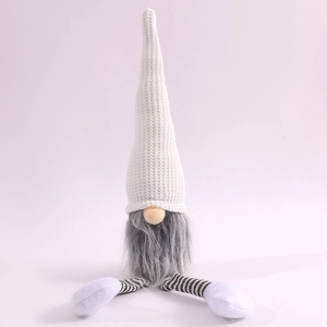 Detail of Christmas gnome with white knitted hat, grey beard and striped hanging legs