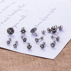 Vintage stainless steel skull and flower ear stud set with a retro silver finish