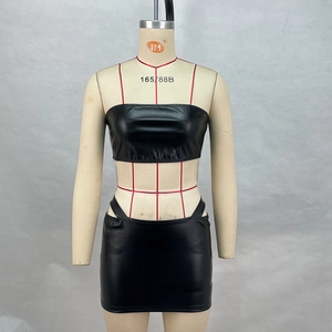 Detail of black PU leather two-piece set featuring lace-up side mini skirt and tube top