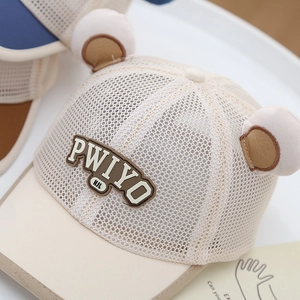 Close-up of beige mesh toddler baseball cap featuring 3D bear ears and soft rubber badge