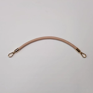 Close-up of beige PU leather handbag strap with golden metal spring hooks for replacement