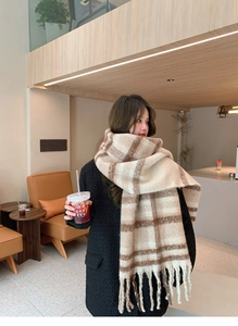 Detailed view of thick mohair plaid scarf with long fringe tassels in cream and brown