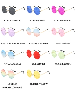 Flat lay of rimless octagon sunglasses with engraved spider web lenses in multiple colors