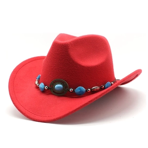 Detailed view of red felt cowboy hat with turquoise beads and silver metal ornaments