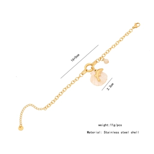 Detail view of gold stainless steel seashell bracelet with dolphin charm and dimensions