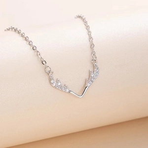 Macro shot of silver deer antler pendant with pavé set cubic zirconia on O-chain