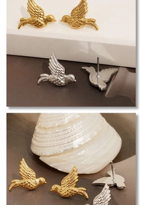 Macro shot of bird-shaped stud earrings showing detailed feather texture and polished finish