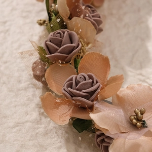 Macro shot of handmade champagne and dusty pink foam roses with tulle mesh leaves