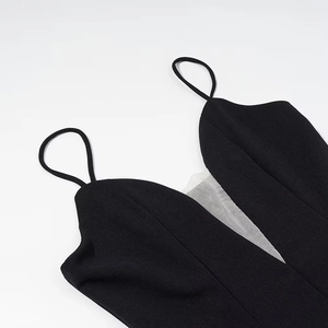 Elegant black sleeveless dress featuring chic polka dot mesh panels and thin spaghetti straps