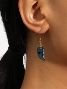 Close-up of a blue translucent ghost pendant earring worn to show material and size