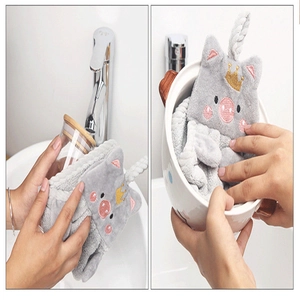 Close-up of gray pig-shaped coral fleece hand towel showing soft absorbent material