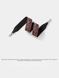 Detail of black Paisley embroidery strap with silver hardware and leather ends