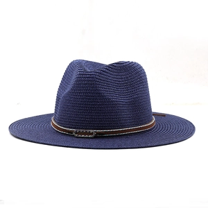 Detailed close-up of dark blue straw fedora with brown leather band and metal buckle