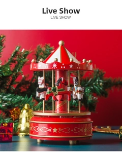 Detailed view of a red wooden carousel music box with gold stars for Christmas decor
