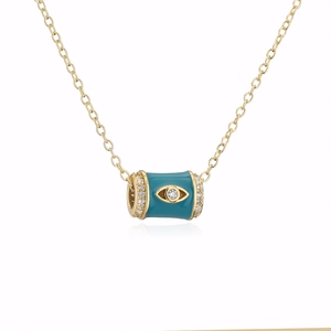 Detail of 18K gold necklace featuring a teal enamel cylinder pendant with an evil eye motif