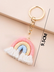 Detail shot of a handmade rainbow keychain with colorful cotton ropes and gold metal ring