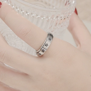 Spinner fidget ring in titanium steel with insect relief shown worn on hand
