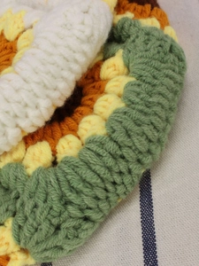 Handmade crochet sunflower handbag with yellow petals and green edge detailing