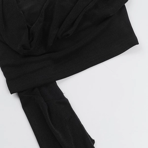 Close-up of the black knitted fabric texture and shoulder strap detail of this top