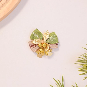 Detail of Christmas burlap bow with metallic gold bell and green holly leaves decoration
