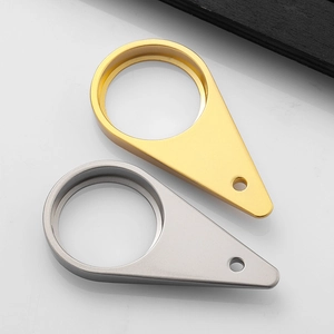 Detailed view of teardrop-shaped metal jewelry pendants in gold and silver finishes
