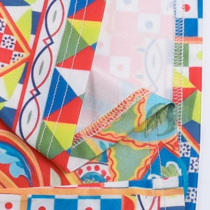 Macro detail showing colorful geometric print fabric with high-quality overlock stitching