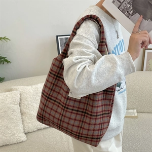 Casual vintage plaid wool tote bag styled on model with a cozy autumn winter outfit