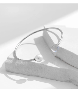 Close-up of S925 silver open bracelet with white pearl and faceted crystal stone