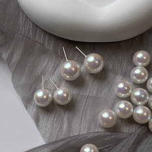 French vintage aurora pearl earrings with 925 silver needles on gray silk fabric