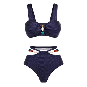 Detailed view of dark navy textured bikini with colorful handcrafted bead ornaments