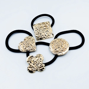 Set of 4 elegant elastic hair ties with textured gold alloy shapes for ponytails