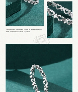 Macro detail of s925 silver heart ring with pavé diamonds and hollow design