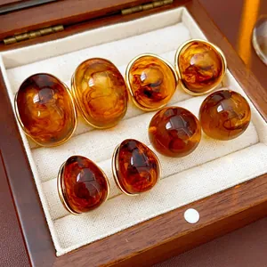 Retro resin round amber earrings with gold trim presented in a luxury wooden box