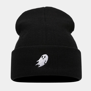Close-up of ghost embroidery detail on black knit beanie for Halloween fashion wear