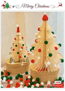 Detail of paper folding Christmas trees with colorful plush balls and red knit hats