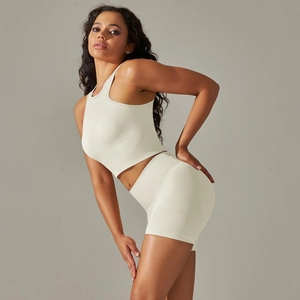 Detail view of seamless cream knit sports bra and high-waisted shorts fitness set