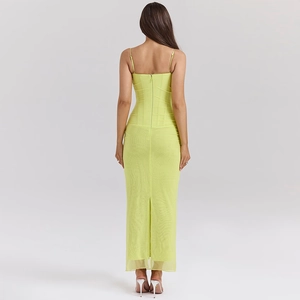 Detail view of a yellow mesh long dress with a slim-fit back zipper and slit