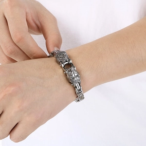 Close-up of vintage silver double lion head bracelet with heavy steel curb chain