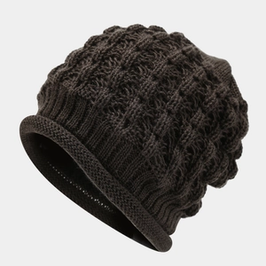 Detail of chunky knit pattern on dark brown beanie showing deep square texture