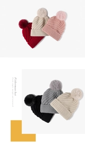 Detail of multi-color ribbed knit beanies with fluffy faux fur pom poms for winter