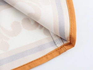 Close-up of cotton linen fabric texture with orange piping and detailed stitching