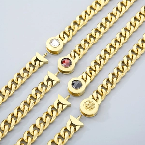 Detailed close-up of Cuban link chain necklaces with magnetic skull and crystal clasps