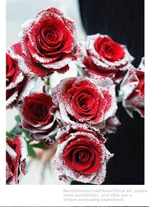 Close-up of red roses with artificial snow effect for Christmas floral arrangements